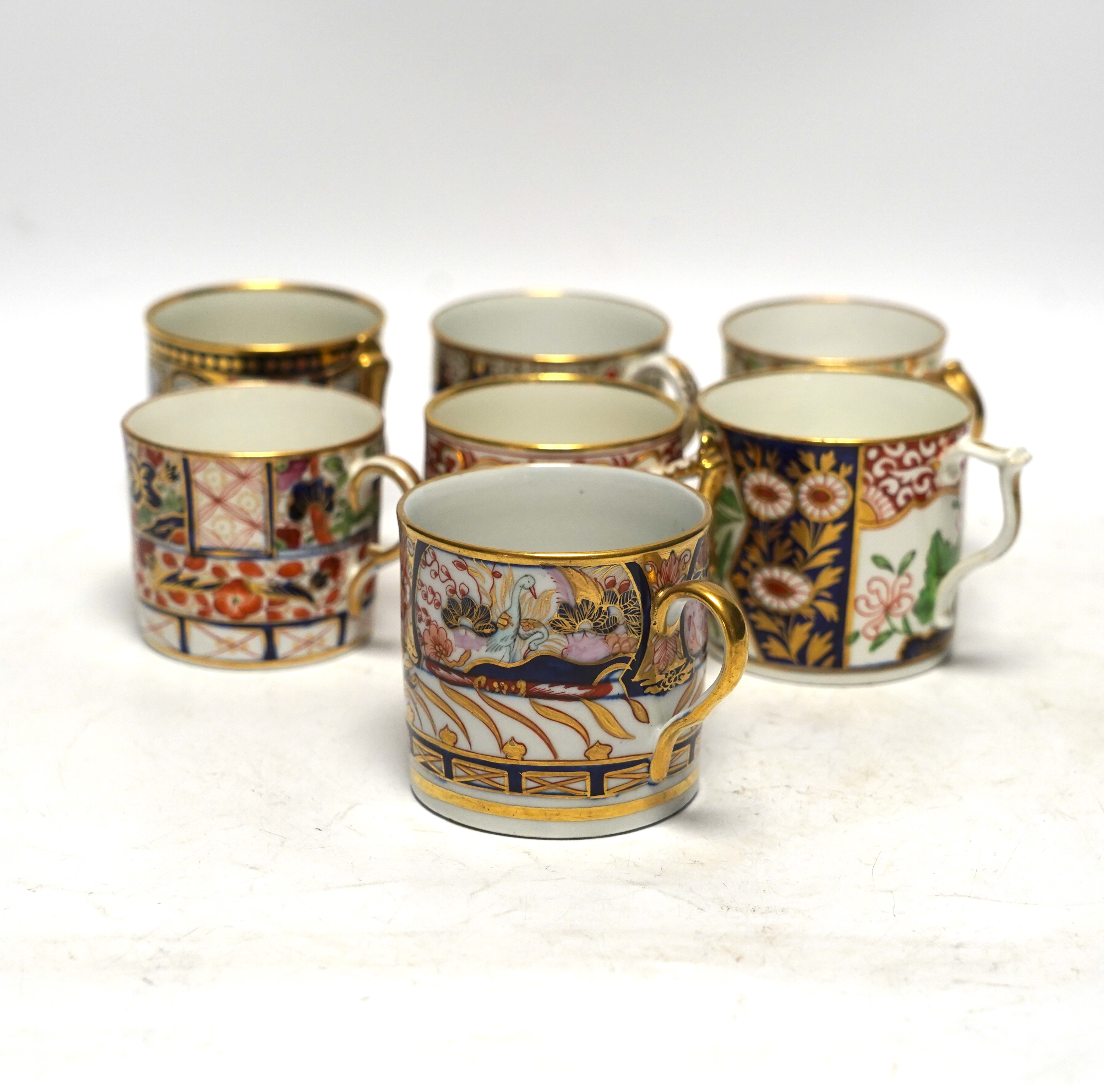 Seven 1800-1820 English porcelain coffee cans, including Imari pattern examples